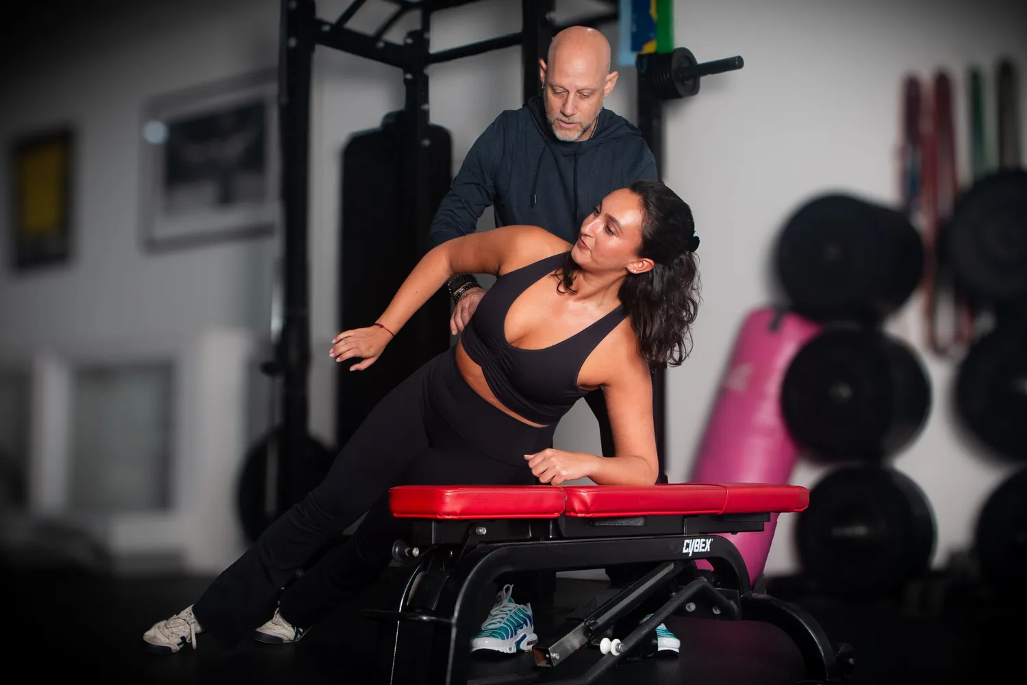 Joel Proskewitz assessing a patient's spine under load in the gym